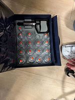 Open carry case showing 16 suction cups and hand pump