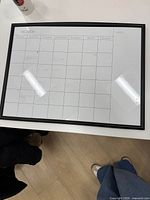 Front view of whiteboard showing full monthly planner grid and frame