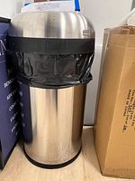 Open-top stainless steel can with black trim ring