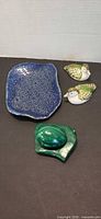 Full lot with two ceramic birds, blue dish, malachite egg on base