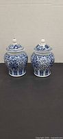 Front view of two blue and white ginger jars with lids