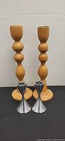 Group shot: two tall wood candlesticks and two short metal candlesticks