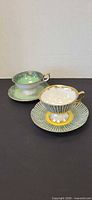 Both teacup and saucer sets displayed