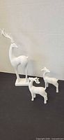 All three white deer figurines grouped