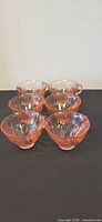 All six pink glass cups arranged