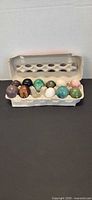 Dozen assorted stone eggs in egg carton