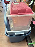 Stacked bins showing blue tote, clear bin, pink bin and small bin with raspberry lid