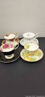 Four Royal Albert cup and saucer sets showing pattern variety