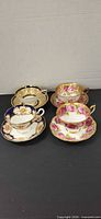All four teacup and saucer sets grouped
