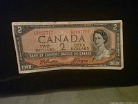 Obverse of 1954 Canadian $2 note showing denomination, serial A3897717, Queen Elizabeth II portrait