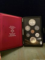 Open case displaying seven proof coins and red interior stamped Royal Canadian Mint