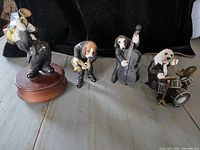 All four dog musician figurines displayed on tabletop