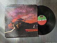 Front of sleeve and vinyl record showing label