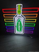 Front view lit showing bottle graphic and multicolour LED bars
