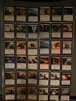 Front view of 36 Magic: The Gathering cards arranged in four nine-pocket binder pages