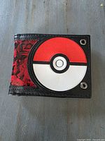 Front of wallet showing Poké Ball design and red character print