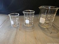 Three Pyrex beakers displaying graduations and sizes