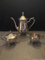 All three matching silver-tone tea service pieces