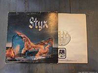 Front cover of Styx Equinox LP next to original inner sleeve with A&M logo