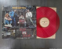 Front sleeve and red vinyl record displayed