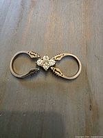 Ring laid flat showing hinged double-band and rhinestone cluster