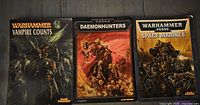 Front covers of three Warhammer rulebooks: Vampire Counts, Daemonhunters, Space Marines
