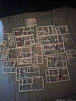 overview of grey sprues with red-painted components