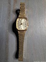 Front view showing dial, case shape and bracelet texture.