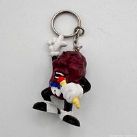 Full view of keychain front showing figure, chain, ring