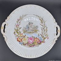 Front view showing entire plate, handles, ribbed rim, central boy scene