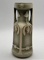 Full front view of vase showing floral relief and gradient glaze