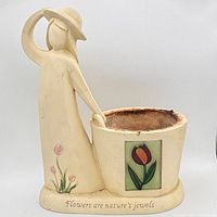 Front view showing figurine, pot, tulip artwork and inscription