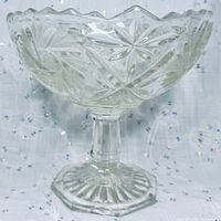 Overall view of crystal pedestal compote showing starburst cuts and scalloped rim