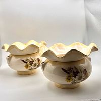 Both assembled planters showing floral design and ruffled rims