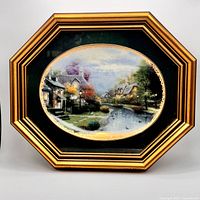 Front view showing framed porcelain plate with artwork and frame details