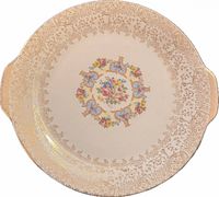 Front view showing gold filigree border and floral medallion