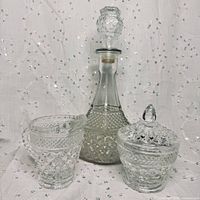 Full set showing decanter, sugar bowl with lid, and creamer