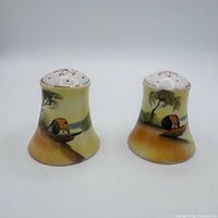 Front view of both shakers showing painted scene and shape