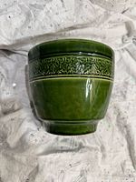 Overall view of green ceramic planter showing glaze and band