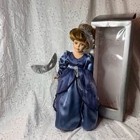 Full view of doll with box background