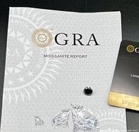 Gemstone on GRA report booklet with warranty card