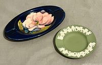 Top view showing both ashtrays, Moorcroft left, Wedgwood right