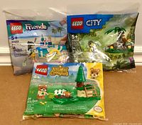 Front view of all three sealed LEGO polybags