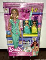 Front view of sealed Barbie Baby Doctor set showing doll, babies, accessories