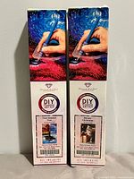 Front view of both boxed Diamond Art Club kits standing side by side