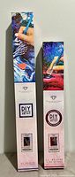 Two sealed Diamond Art Club DIY Art Kit boxes standing upright