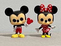 Front view of both Mickey and Minnie vinyl figures