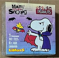 Front of sealed mystery box showing vampire Snoopy illustration and product details
