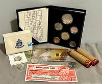 Overview of all items: coin set, penny rolls, gold bar, Canadian Tire note, loose coins, RCM envelope