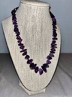 Front view of full amethyst chip bead necklace displayed on bust